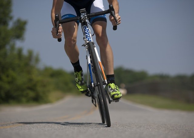 Person Riding Road Bike on the Road types of bikes for trails